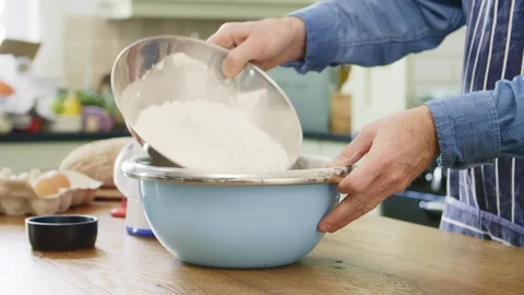 Man Adding Flour And Water In Bowl At Table Stock Footage 86116519