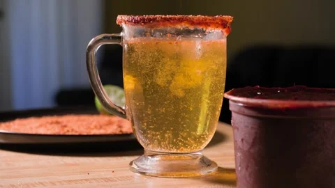 Man Adding Lime and Tajin to Beer Cup for Chamoy Michelada Stock Footage 342681000