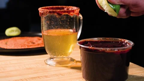 Man Adding Lime To Chamoy Sauce With Beer And Tajin In Background Stock Footage 341560708