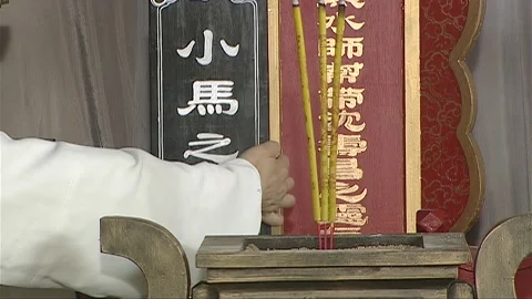 The man is adding new spirit tablets to the ancestral tablet Stock Footage 276516827