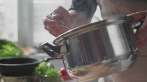 Man Adding Quinoa into Bowl with Vegetables Stock Footage 147313829