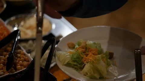 Man adding ranch salad dressing to his salad at a salad bar slow motion 스톡 동영상 85842379