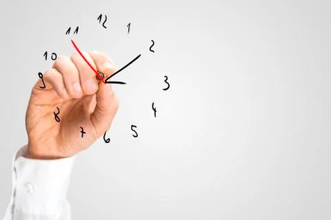 Man adding a second hand to a hand-drawn clock Stock Photos