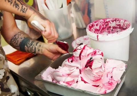 Man adding the variegating to fruit ice cream Stock Photos