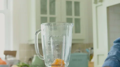 Man Adding Various Fruits And Water In Blender At Kitchen Stock Footage 86074622