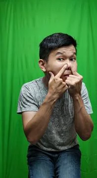 A Man Addressing Blemishes with a Squeeze, Emphasizing Personal Care Stock Photos