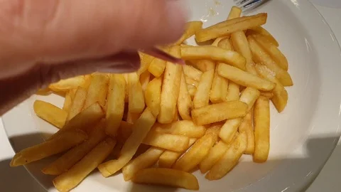 Man adds ground pepper to fried potatoes Stock Footage 119354582