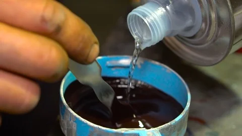 Man adds a solvent to the paint Stock Footage 80929853