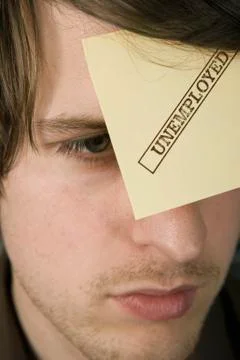 A man with an adhesive note on his forehead stamped 'Unemployed' Stock Photos