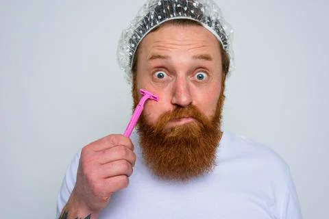 Man adjust the beard with a razor blade Stock Photos