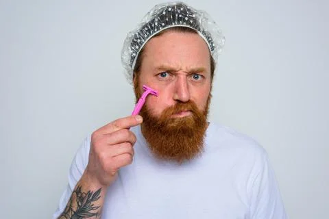 Man adjust the beard with a razor blade Stock Photos