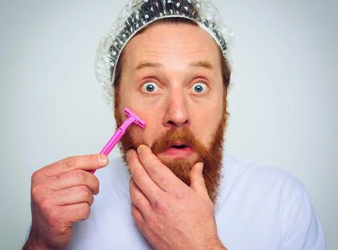 Man adjust the beard with a razor blade Stock Photos