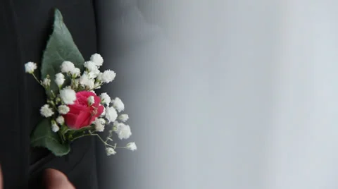 The man is adjusting a boutonniere Stock Footage 34613214