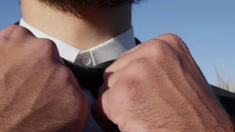 Man Adjusting Bow Tie on White Shirt Stock Footage 320202373