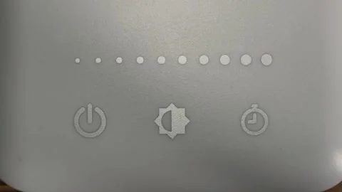 Man adjusting brightness of lamp using high tech touch slider. Video stock 131969296