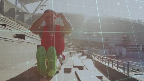 Man adjusting cap folding forward doing forward stretch on stadium with grid Stock Footage 333396965