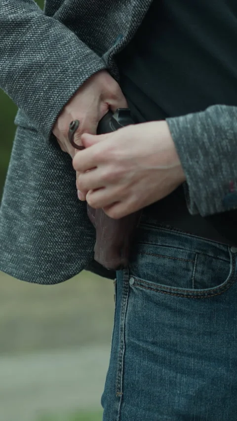 Man Adjusting Concealed Firearm Beside Railway Track Stock Footage 316510531