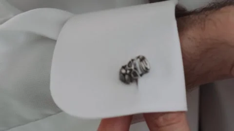 Man adjusting cufflinks on the cuffs of a white shirt Stock Footage 246583879