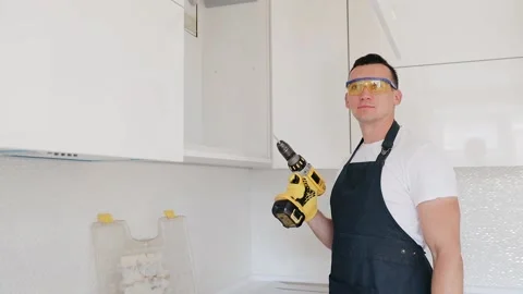 Man adjusting an electric screwdriver. Battery inserts into the skrewdriver Stock Footage 132692999