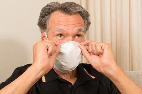Man Adjusting Face Mask Stock Photos