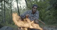 Man Adjusting The Firewood In The Campfire Stock Footage