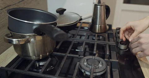 A man adjusting the flame on the top burner of his stove. Stock Footage 129856422