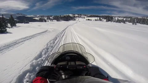 Man adjusting helmet camera  putting on glove and snowmobiling in Colorado Video stock 201924043
