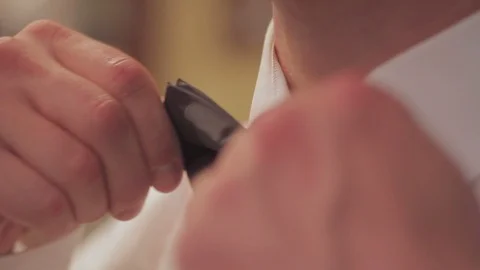The man is adjusting his bow tie, preparing for the holiday. Closeup Stock Footage 86971286