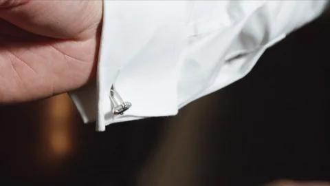 Man adjusting his cuffs on white shirt Vídeos de archivo 108371202