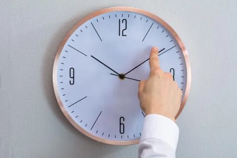 Man Adjusting The Hour Clock Stock Photos