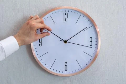 Man Adjusting The Hour Clock Stock Photos
