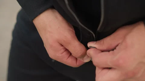 Man adjusting jacket zipper, closeup of man securing outerwear zipper, male Stock Footage 323505389
