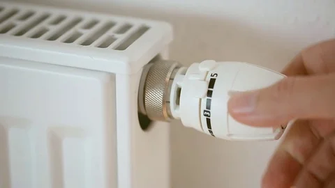 A man is adjusting radiator Stock Footage 81789410