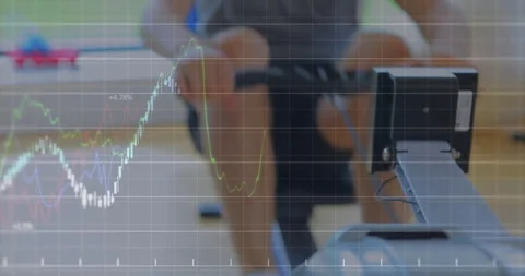 Man adjusting rowing handle and pushing legs on machine generating moving Stock Footage 312017998