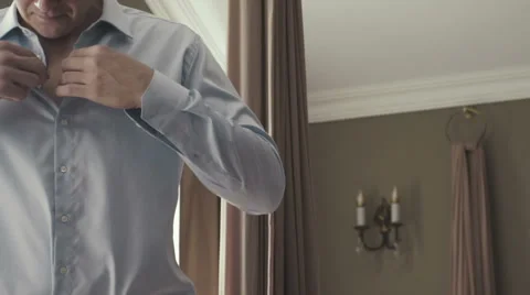Man adjusting shirt buttons. Stock Footage 67570038