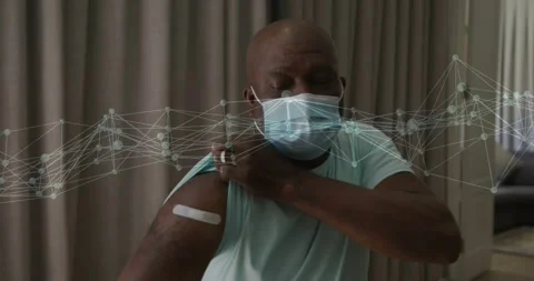 Man adjusting sleeve and pressing patch after shot, network overlay tracing site 스톡 동영상 330356361