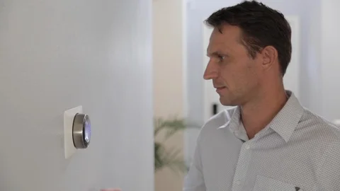 Man Adjusting Smart Thermostat Gadget At Home Stock Footage 120892347