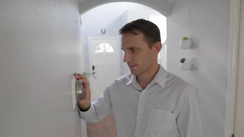 Man Adjusting Smart Thermostat Gadget At Home Stock Footage 120892392
