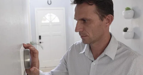 Man Adjusting Smart Thermostat Gadget At Home Stock Footage 120892525