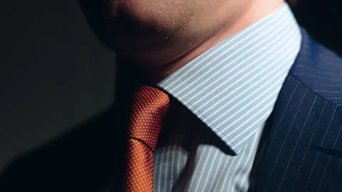 Man adjusting tie. orange tie close up Stock Footage 305203354