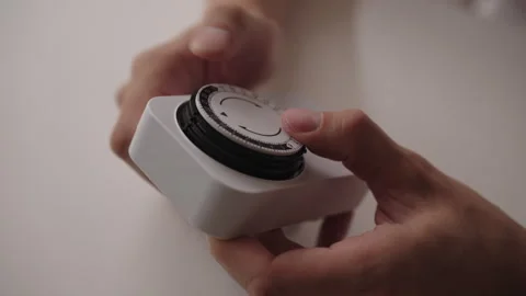 Man adjusting timer switch, ensuring precise control over electrical devices for Stock Footage 318471702
