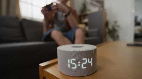 Man Adjusting Volume on Smart Speaker with Digital Display Stock Footage 340813346
