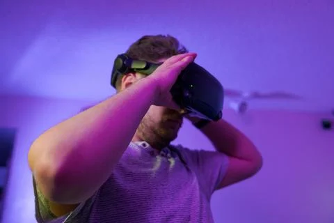 Man adjusting VR headset before immersive digital adventure Stock Photos