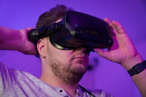 Man adjusting VR headset position on face Stock Photos