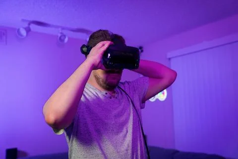 Man adjusting VR headset before starting game Stock Photos