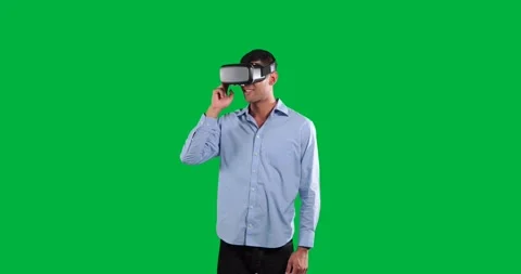 Man adjusting VR headset in studio with transparent background, showing tech Stock Footage 325069952