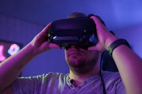 Man adjusting VR headset before virtual gaming session Stock Photos