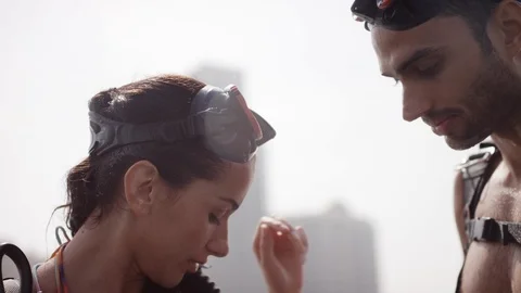 Man adjusting womans scuba backpack. Stock Footage 119392870