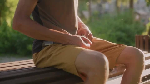 Man Adjusts Clothes In Park, Park Visitor Adjusts Attire With Hesitation Amid Stock Footage 329487901