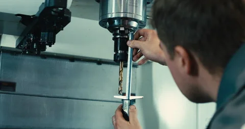 A man adjusts a cnc machine with a drill. Modern industry. Stock Footage 201486918